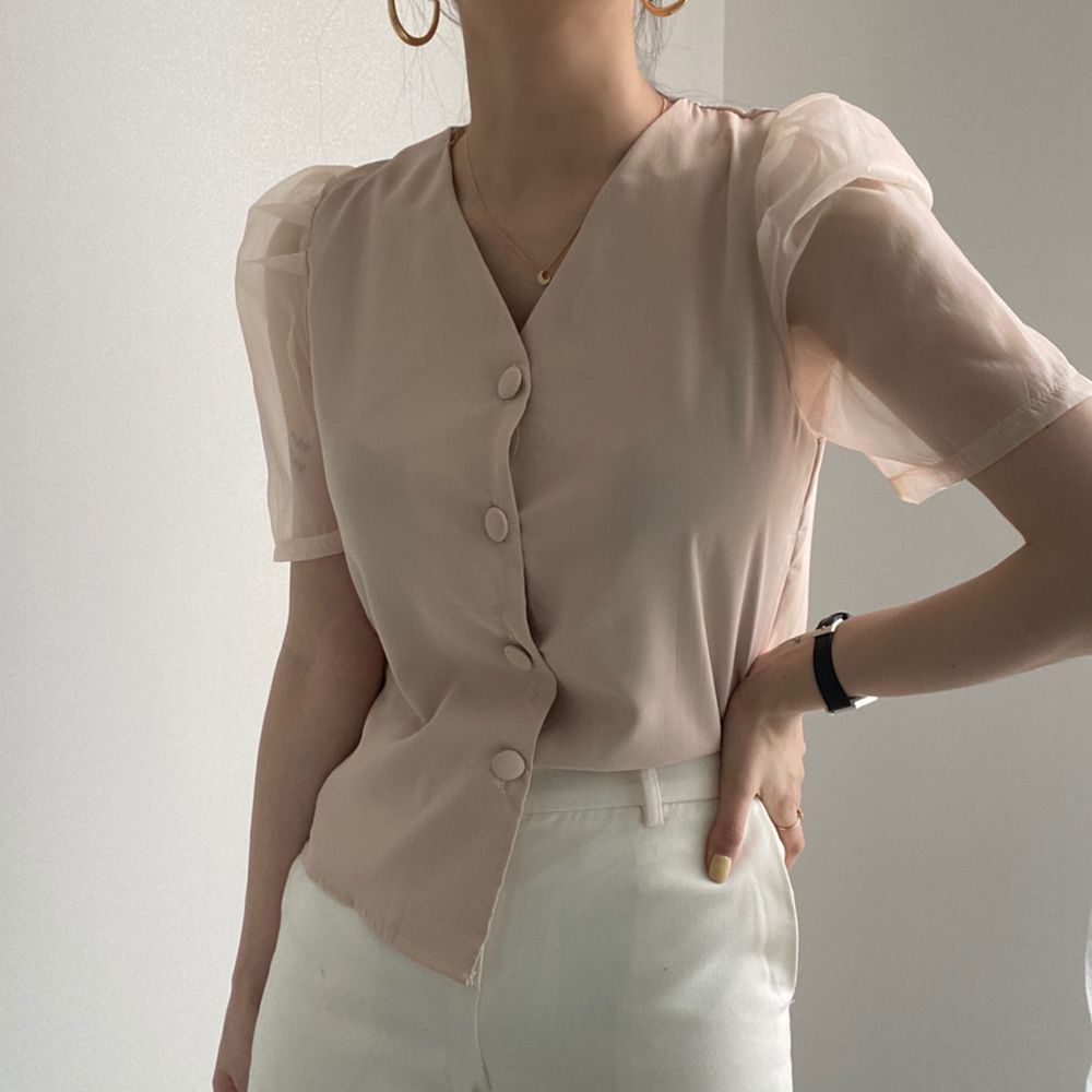 White buttoned blouse with clear sleeve