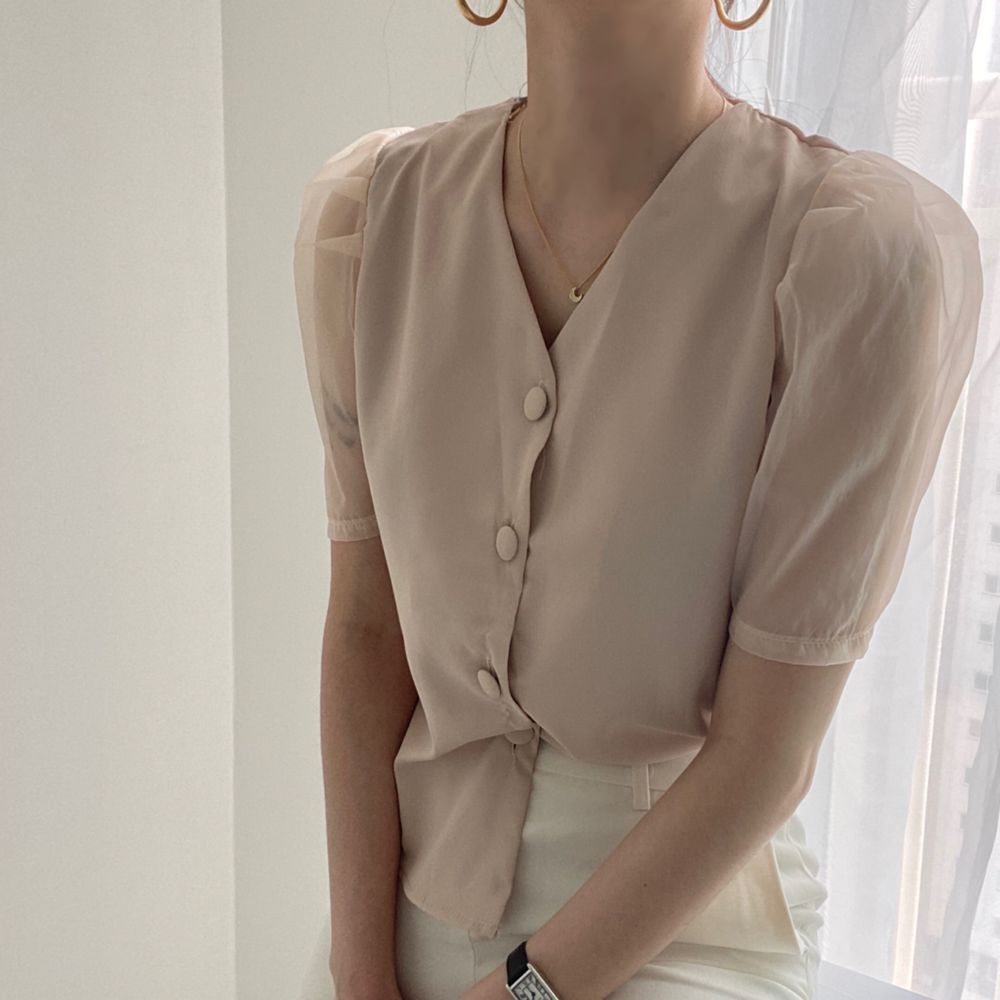 White buttoned blouse with clear sleeve